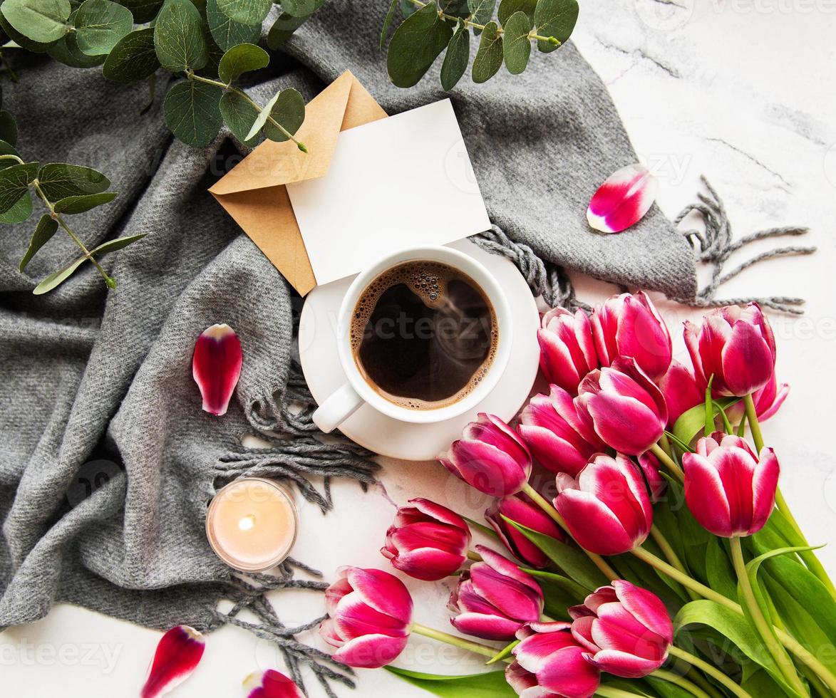 Cup of coffee and pink tulips photo