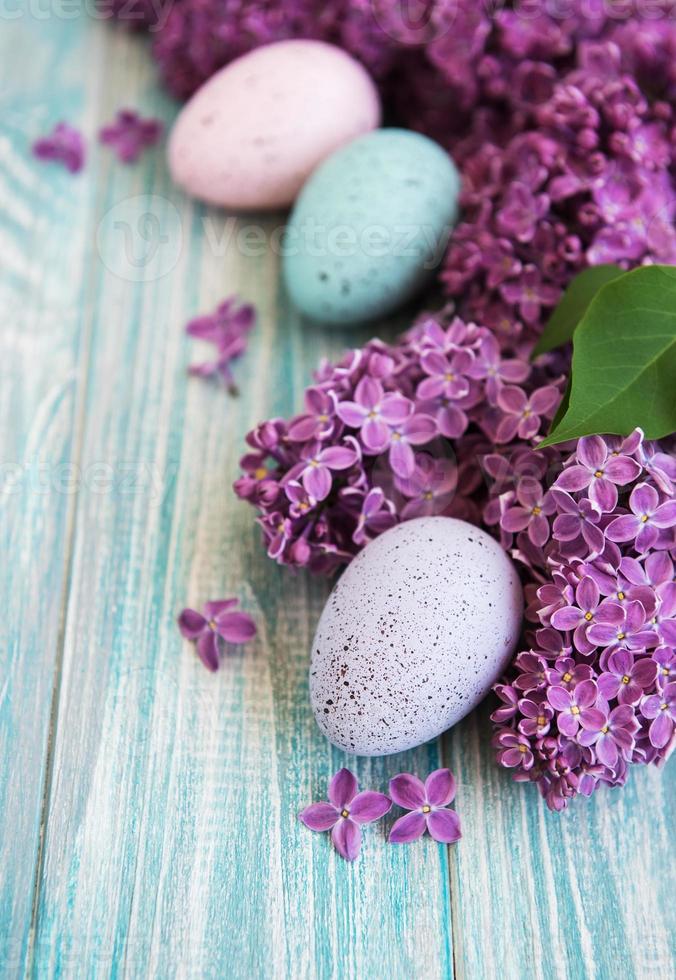 Spring lilac flowers and easter eggs photo