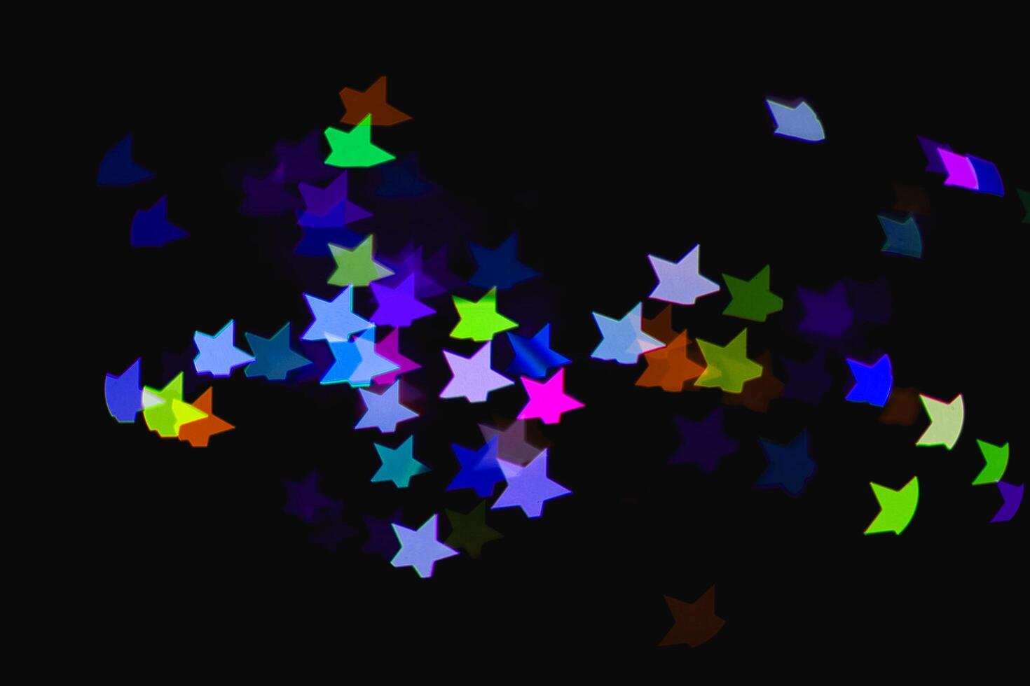 light colorful blue star light effect isolated overlay glitter texture on black. photo