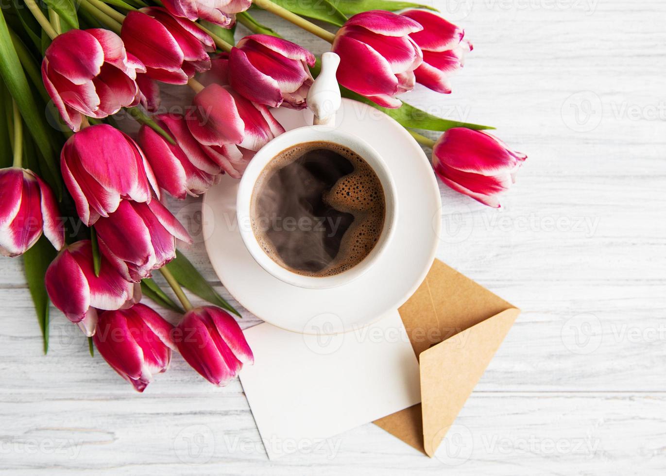 Cup of coffee and pink tulips photo