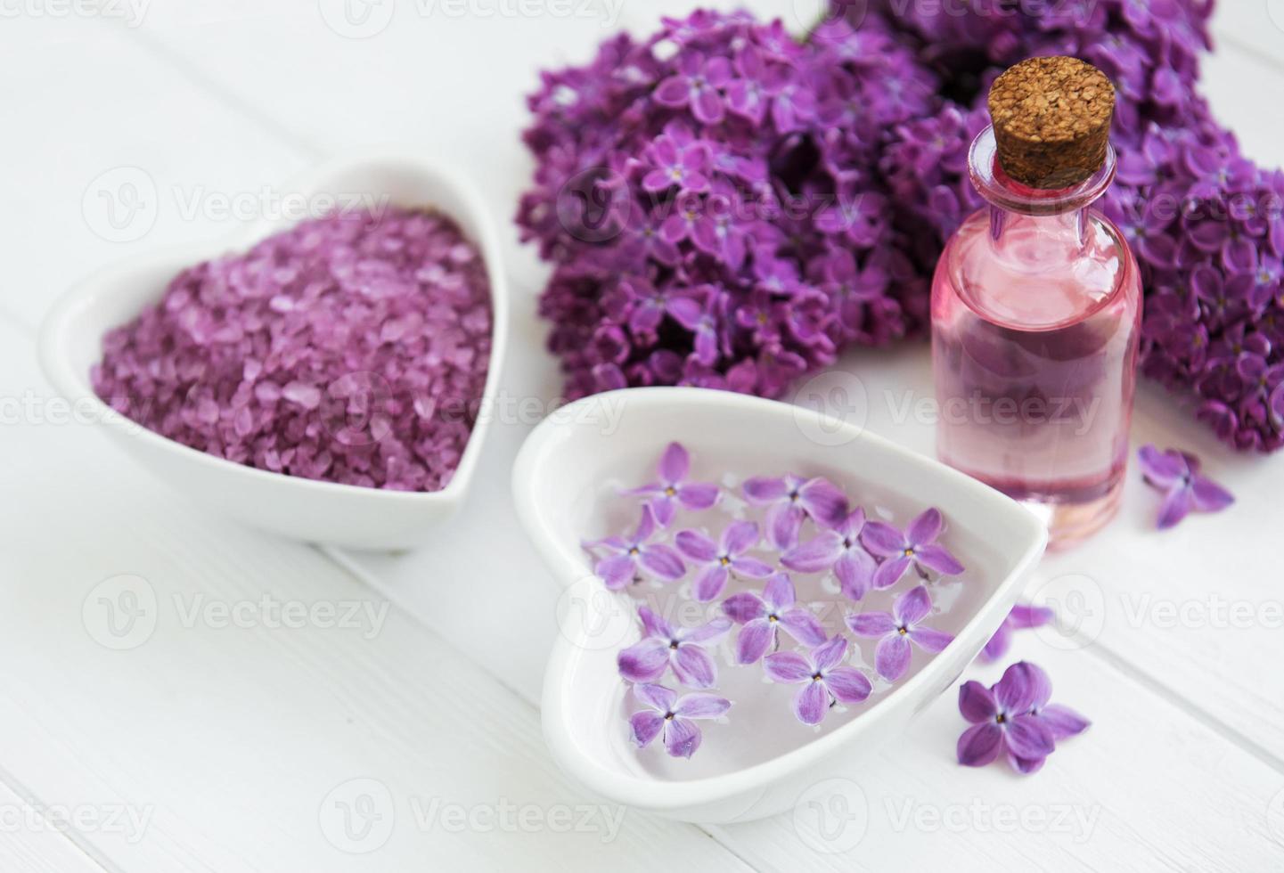 Essential oil with lilac flowers photo