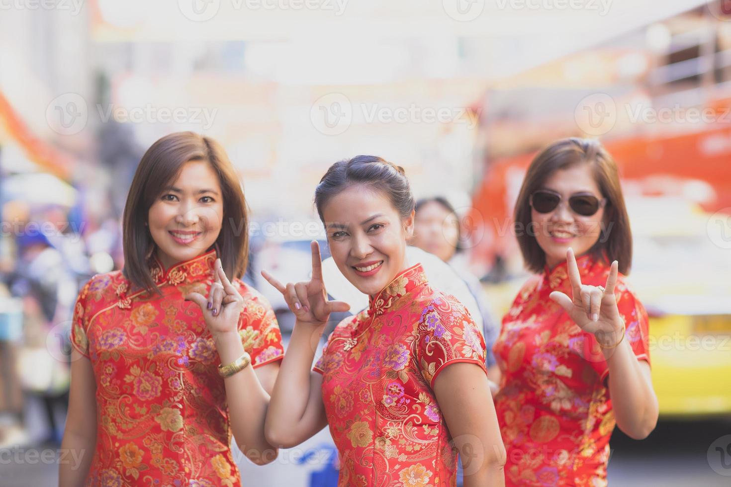 group of asian woman wearing chinese tradition clothes toothy smiling face happiness emotion and hand sign i love you photo