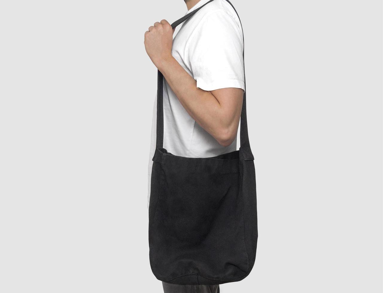 Black tote bag holding model photo