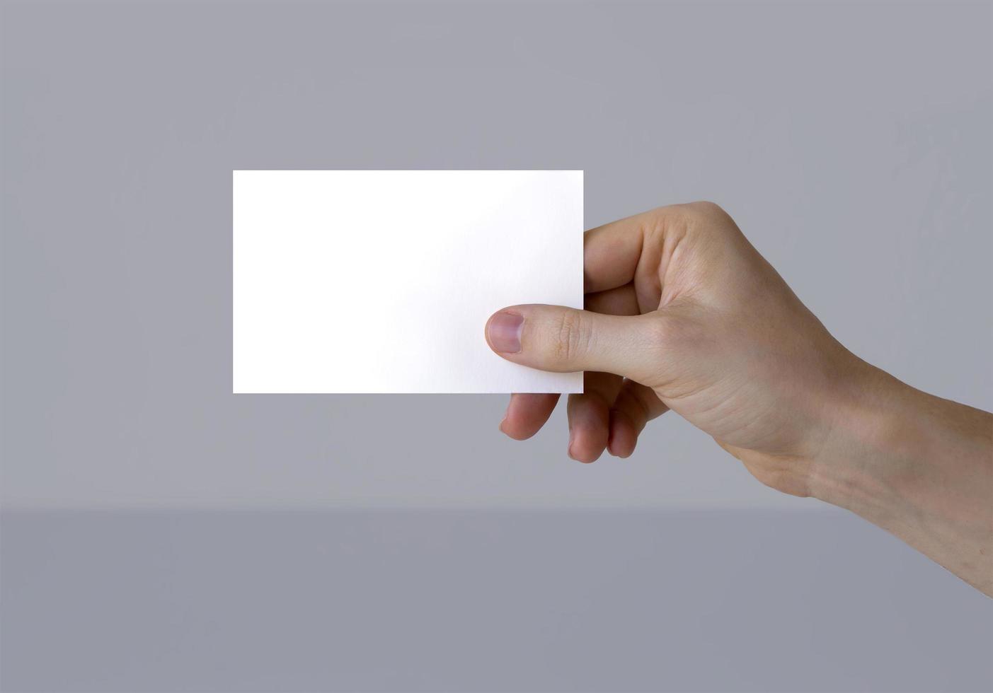 Hand holding a business card template photo