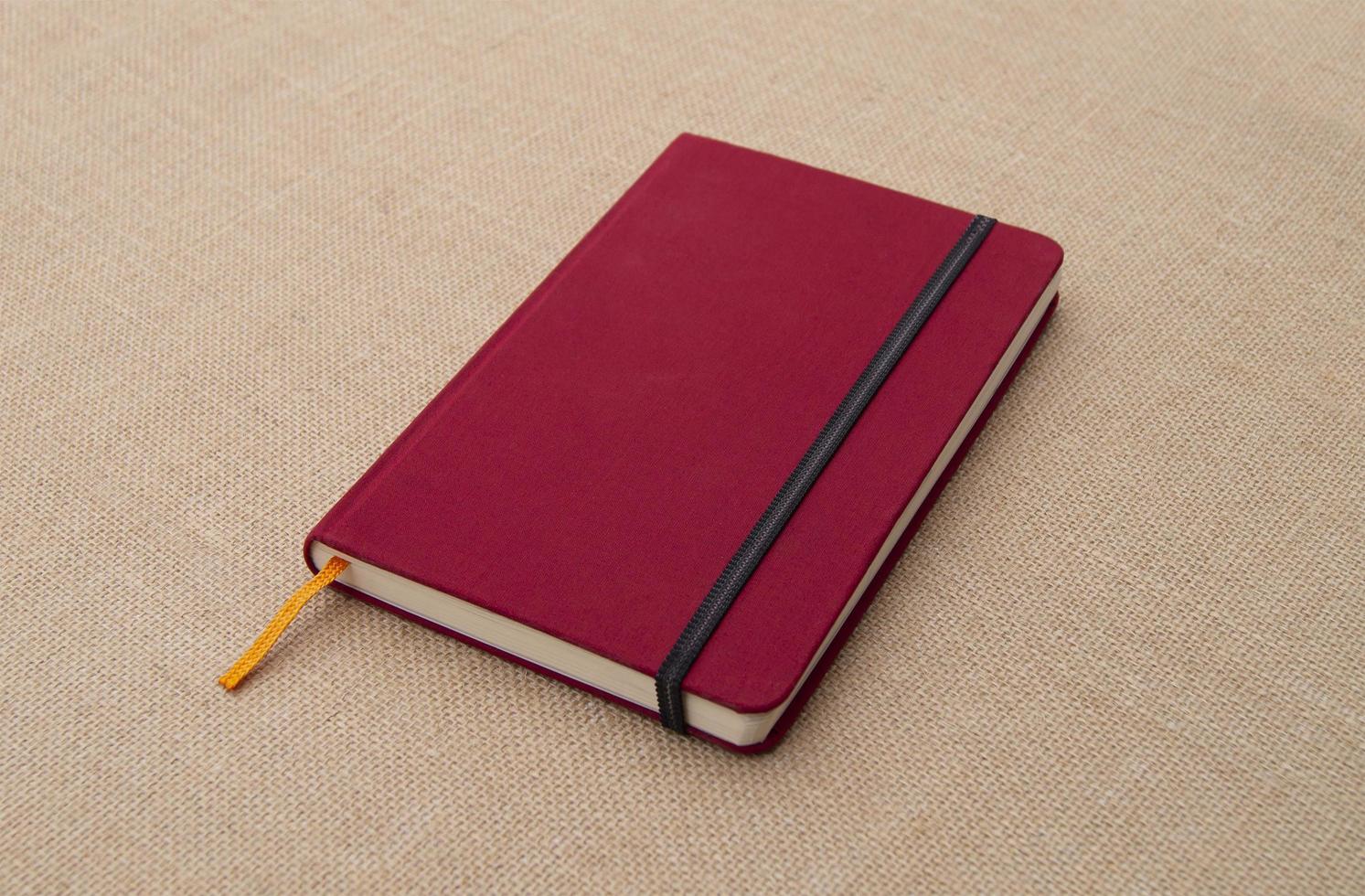 Red Notebook on Fabric Surface photo