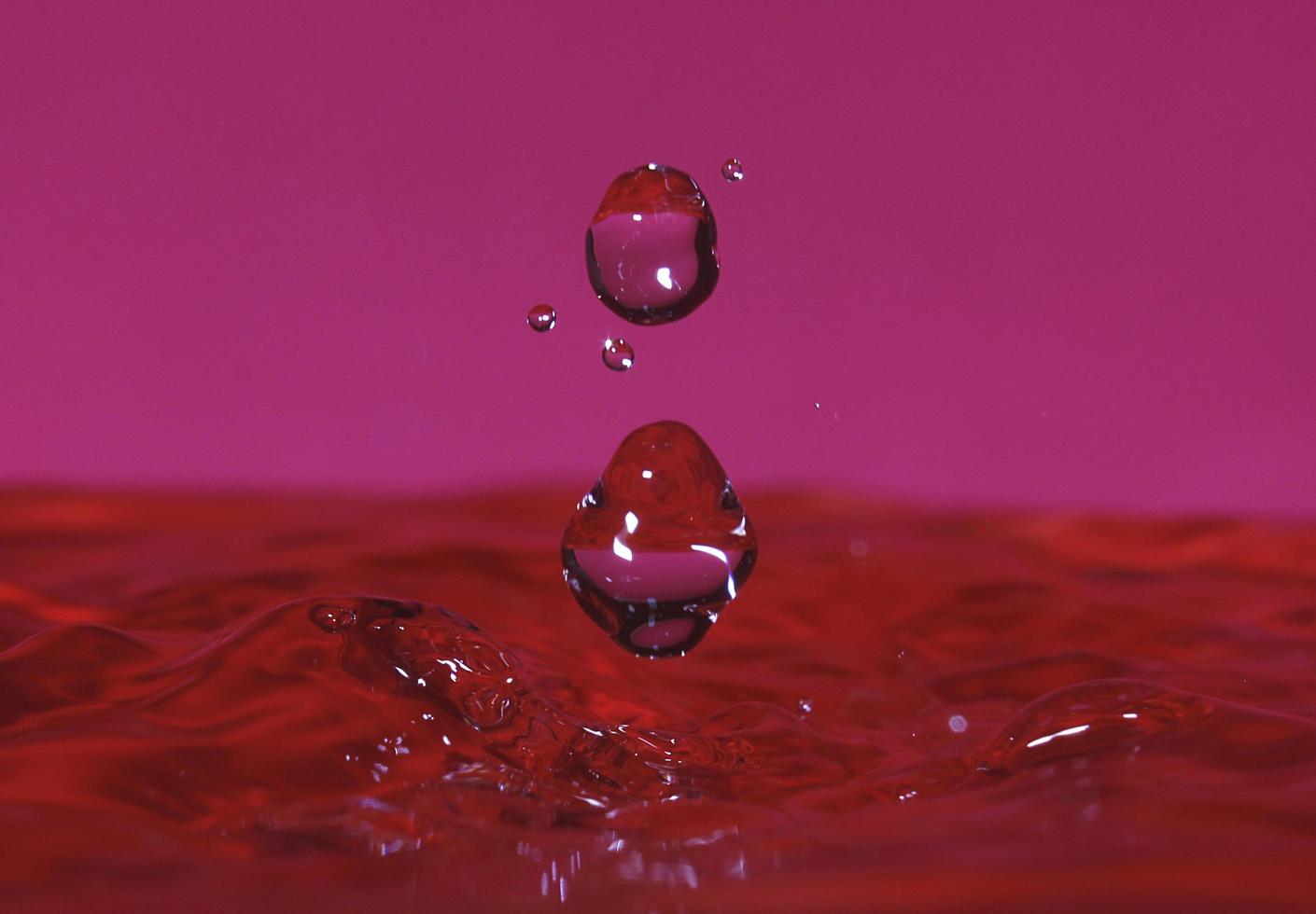 splash resulting from the impact of a drop with a container full of water photo