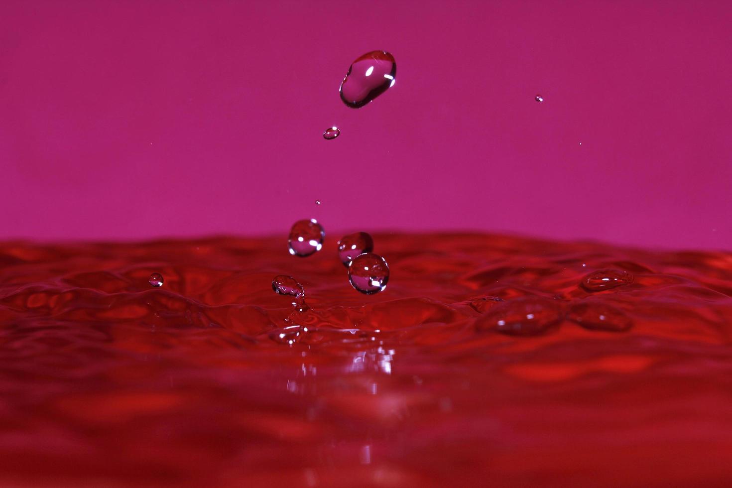 splash resulting from the impact of a drop with a container full of water photo