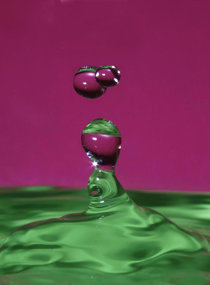 splash resulting from the impact of a drop with a container full of water photo