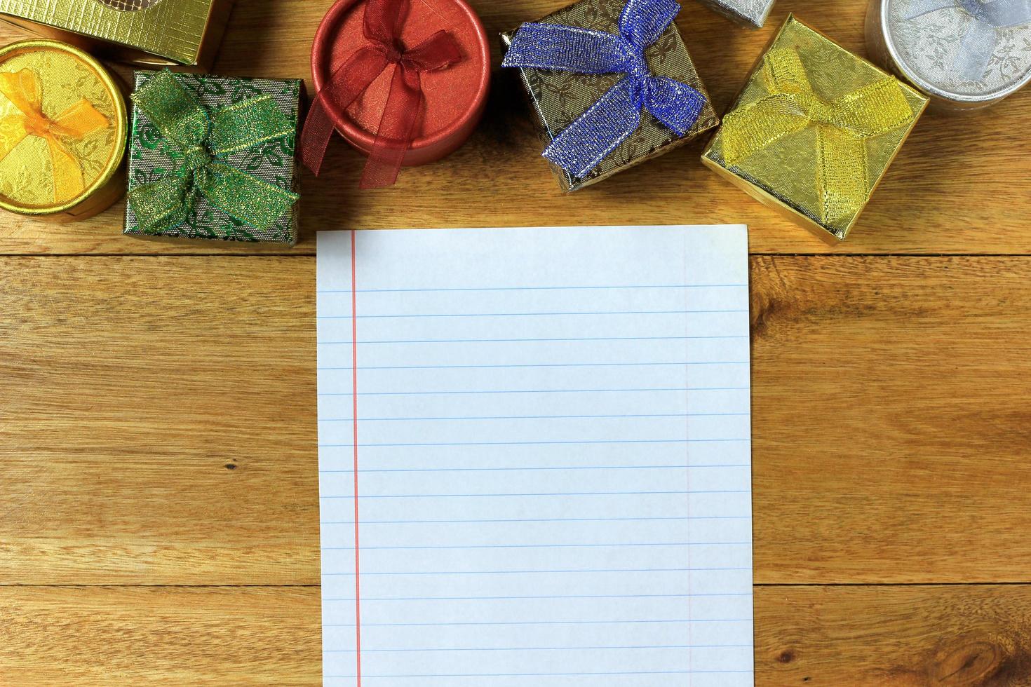 Christmas composition. Christmas gifts on wooden table. Top view, empty space, cardboard photo