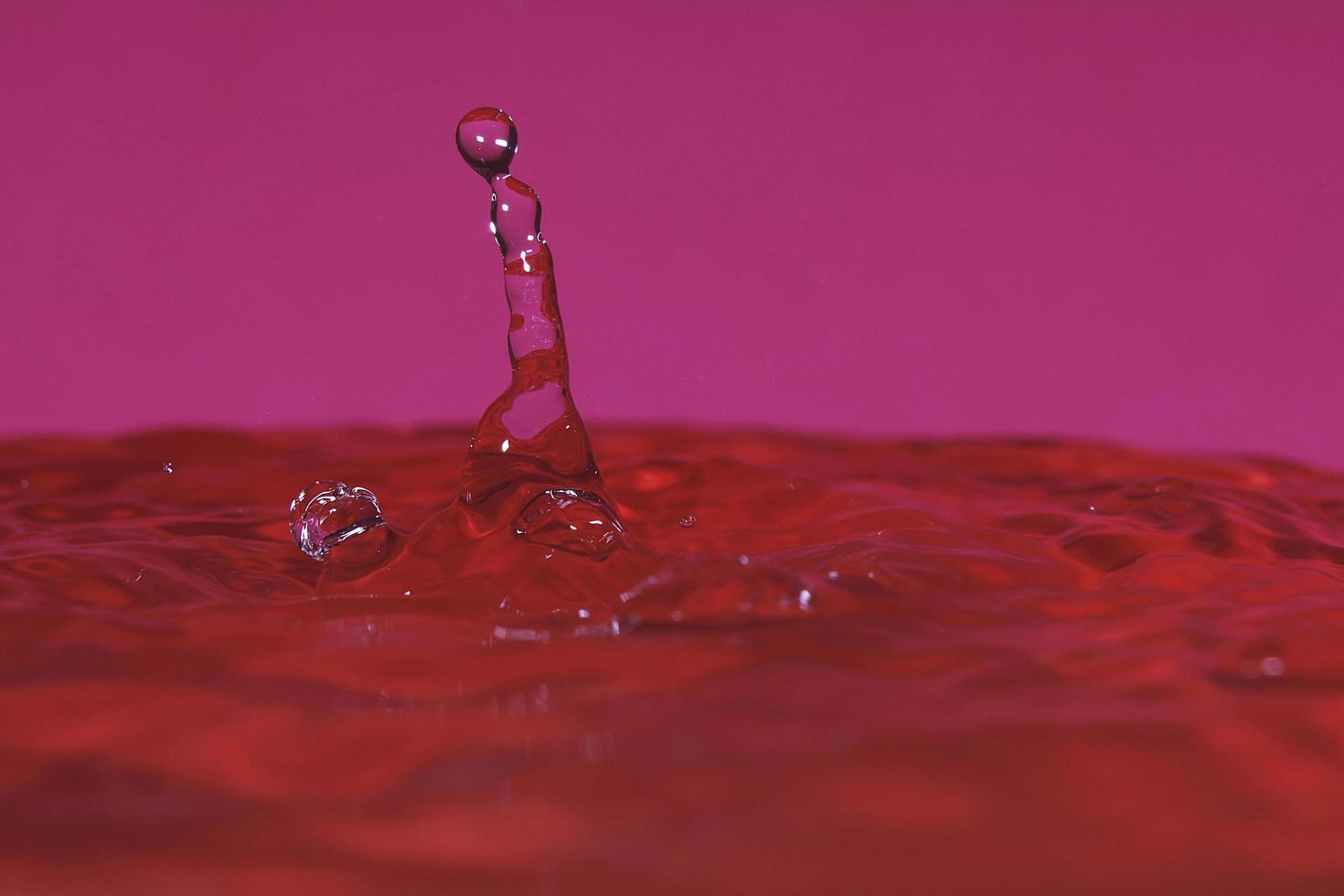 splash resulting from the impact of a drop with a container full of water photo