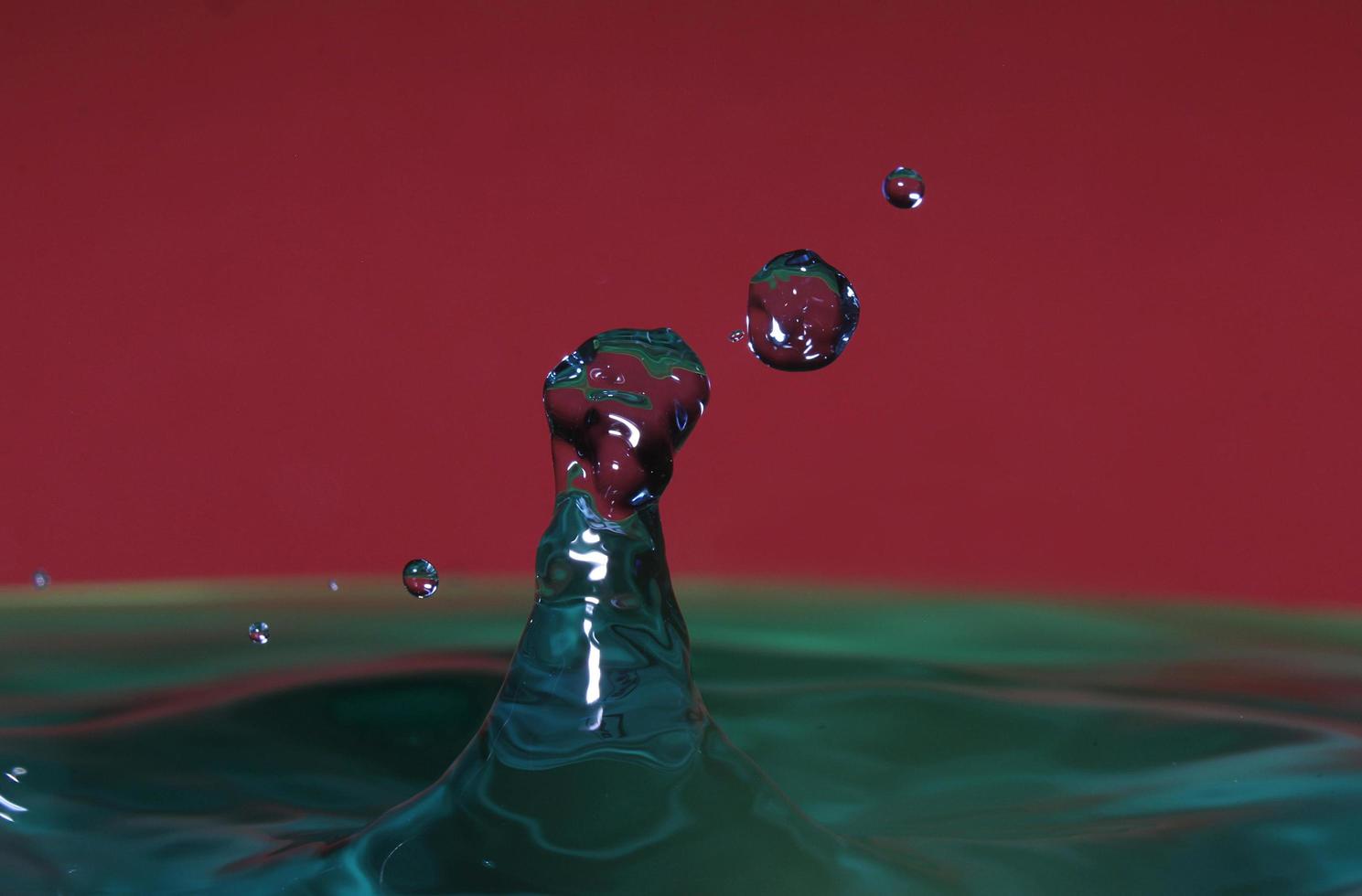 splash resulting from the impact of a drop with a container full of water photo