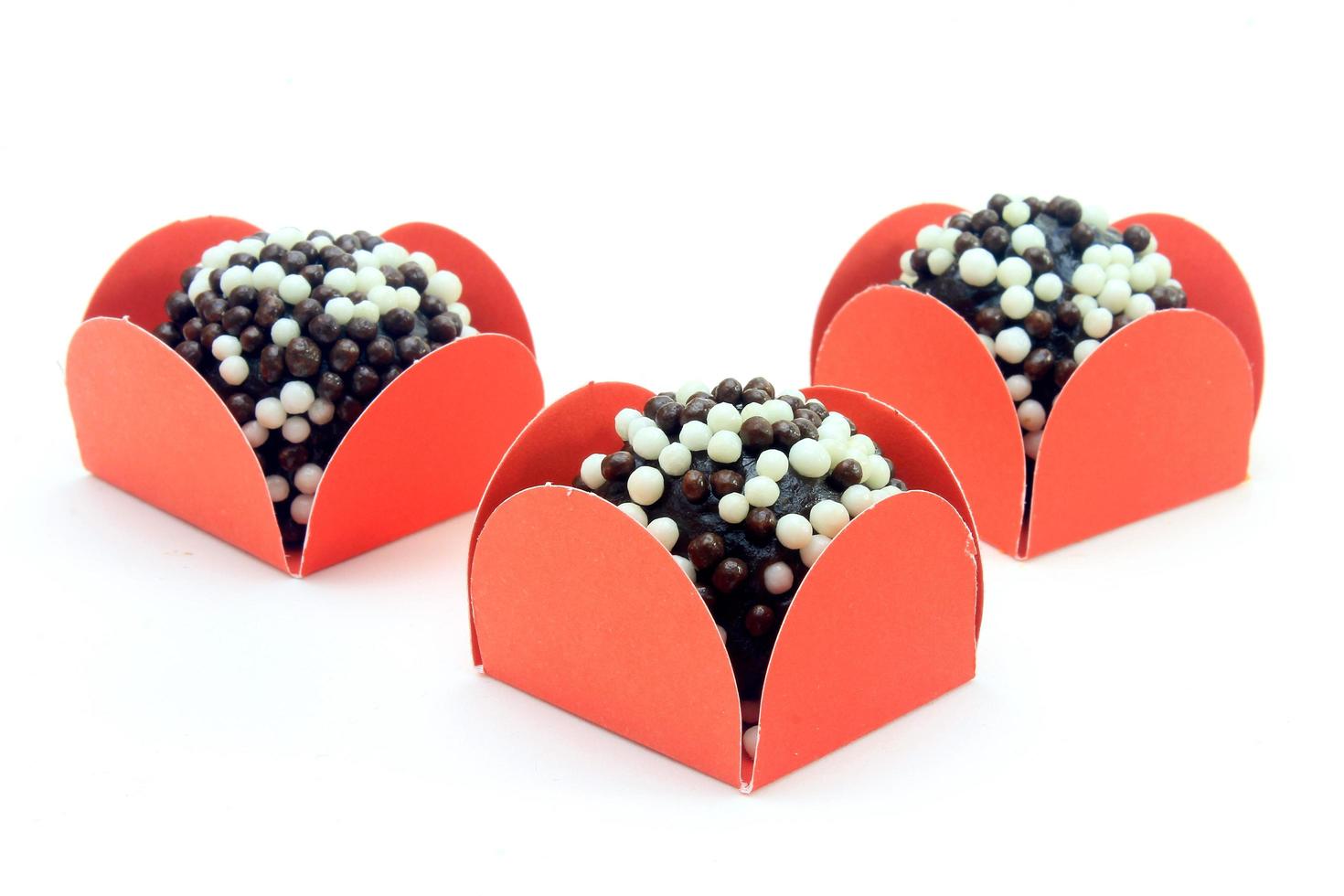 brigadeiro, brigadier, sweet chocolate typical of Brazilian cuisine covered with particles, in a wooden background. photo