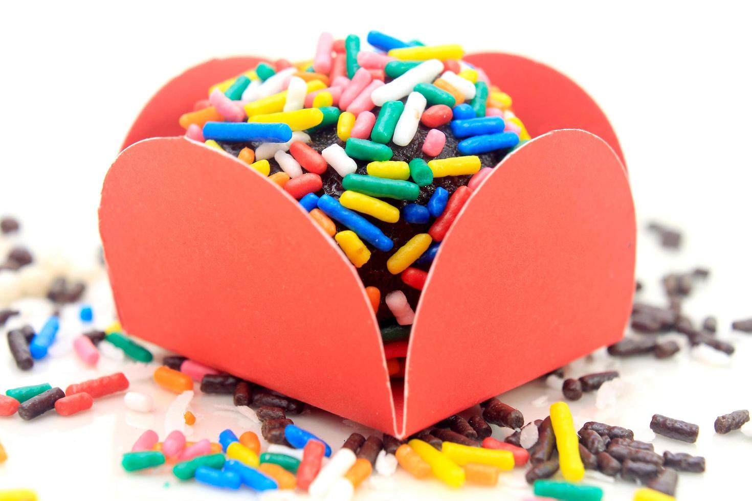 brigadeiro, brigadier, sweet chocolate typical of Brazilian cuisine covered with particles, in a wooden background. photo