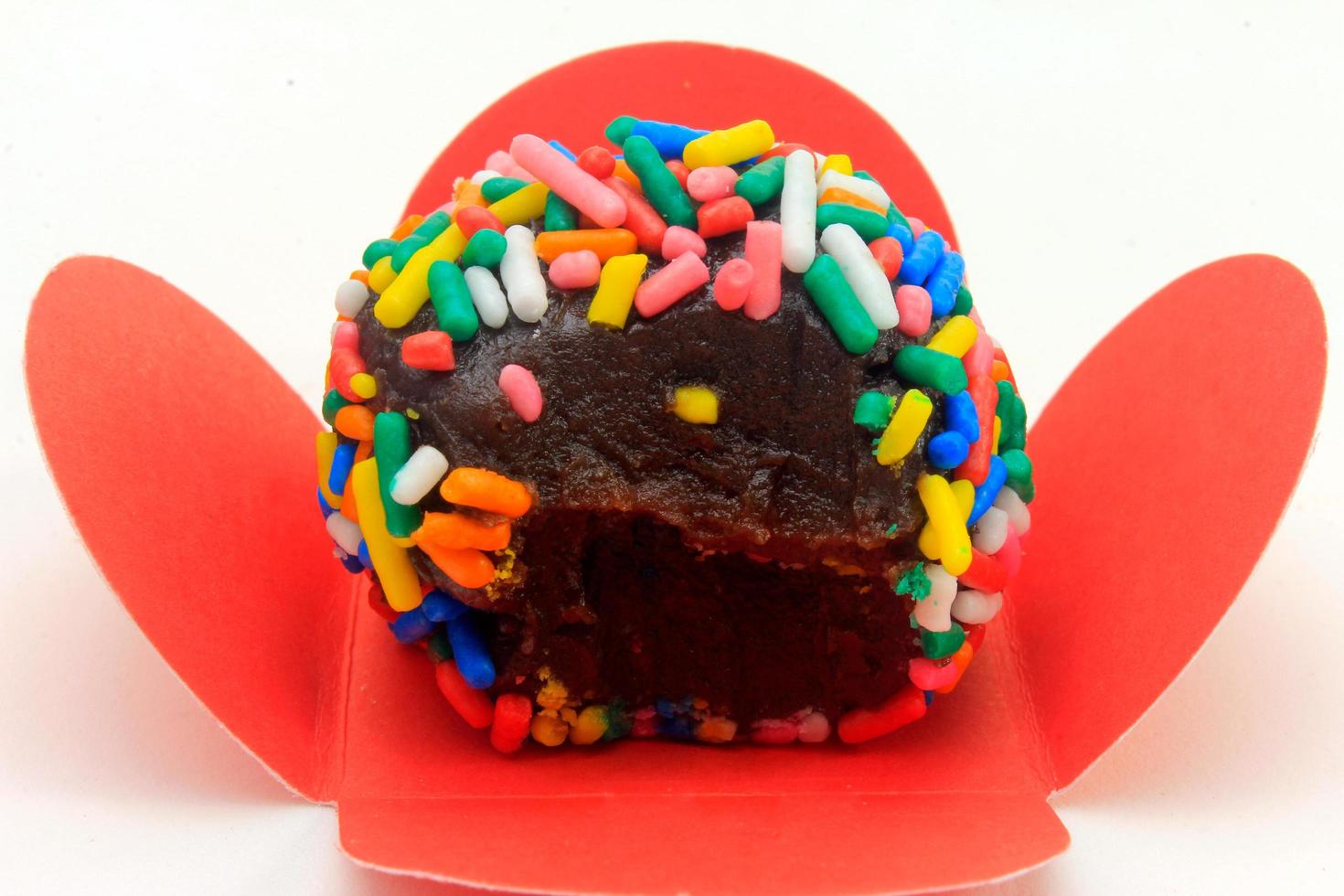 brigadeiro, brigadier, sweet chocolate typical of Brazilian cuisine covered with particles, in a wooden background. photo