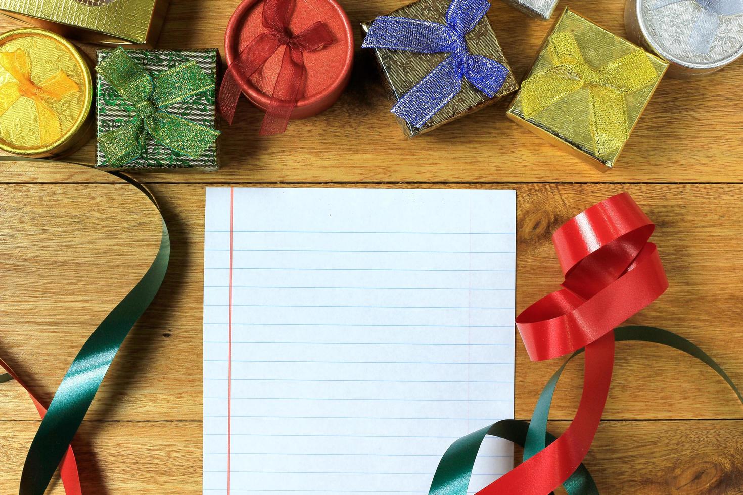 Christmas composition. Christmas gifts on wooden table. Top view, empty space, cardboard photo