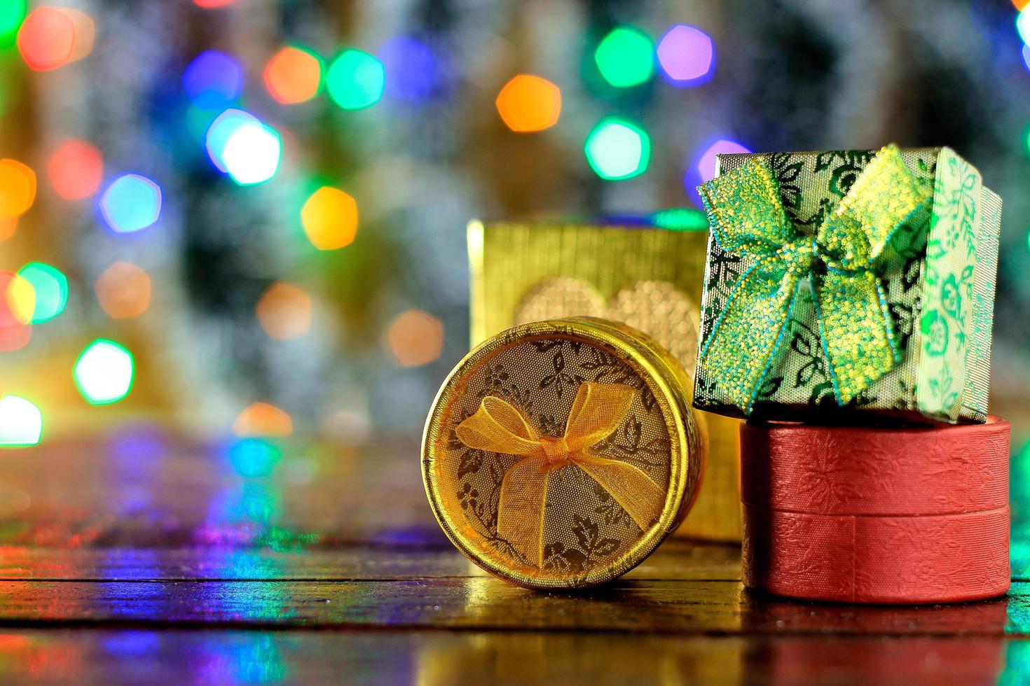 gift boxes on wooden table, christmas decoration, blurred lights photo