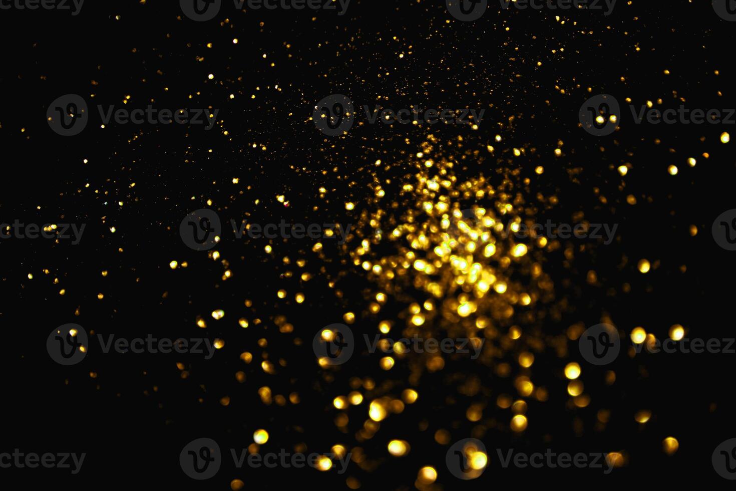 gold abstract pattern glitter stardust sparkling lights grunge on black. photo