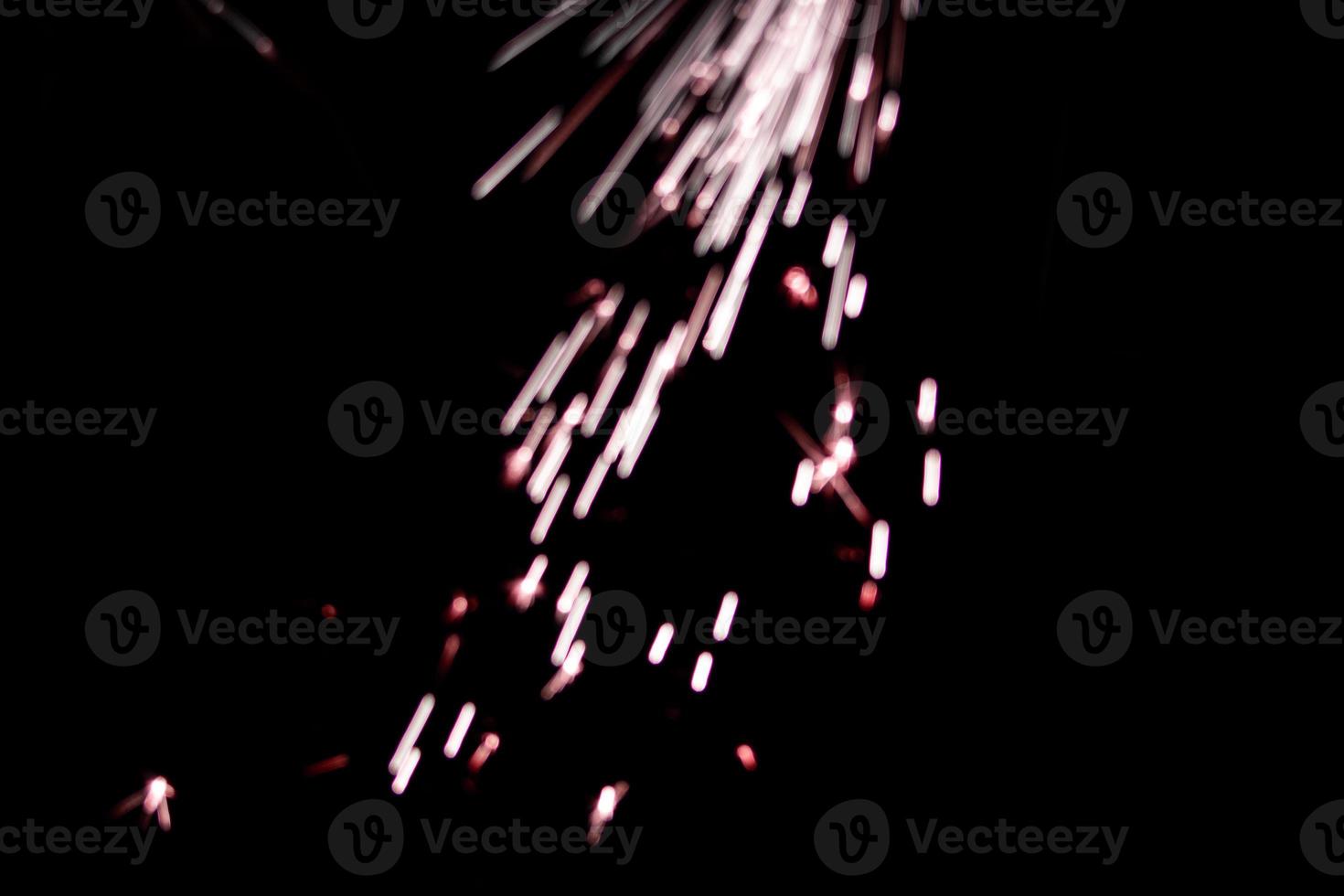 abstract lite red sparkler overlays elegant texture blur sparkling on black. photo