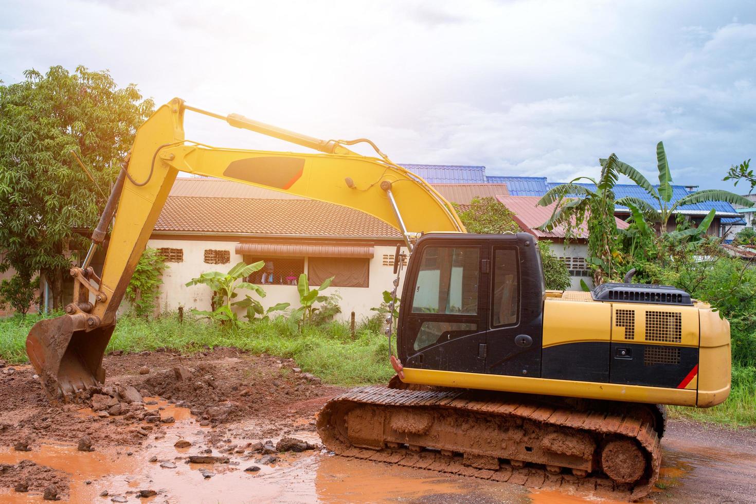 Repair of roads damaged in the rains with car backhoe . photo