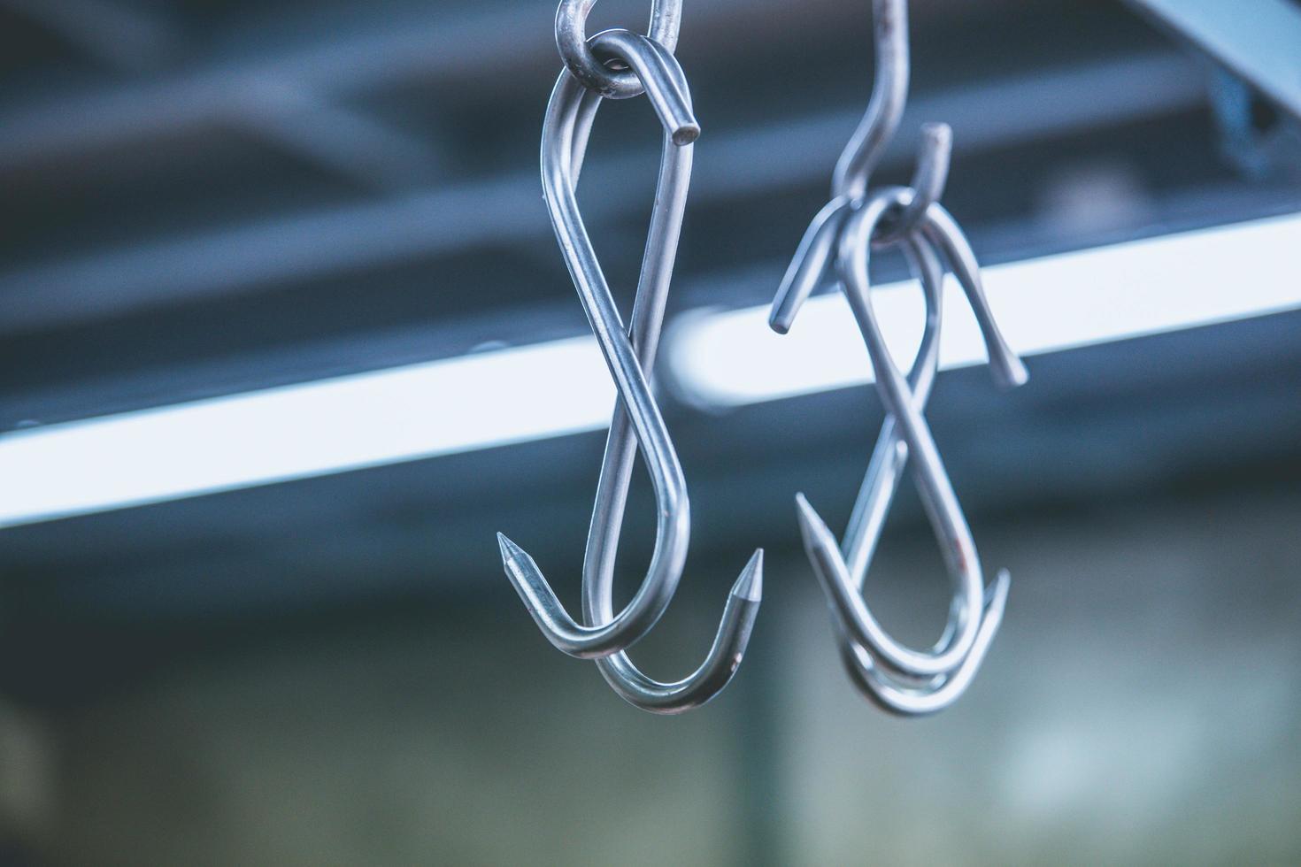 Meat hooks hanging in a slaughterhouse. photo