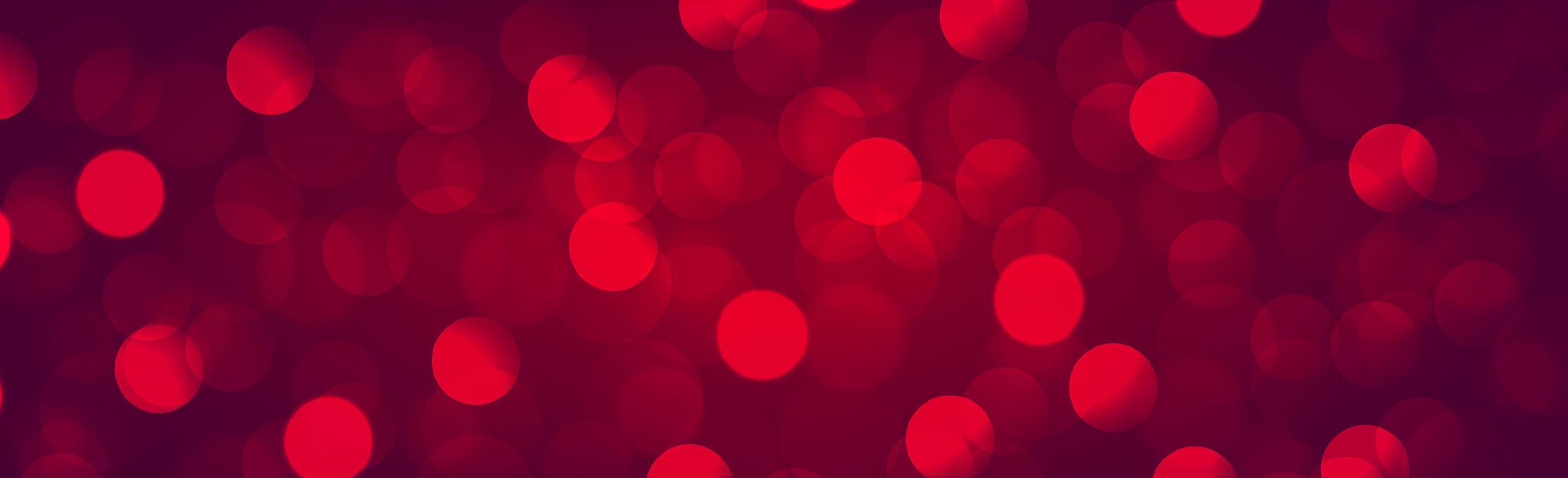 Multicolored blurry bokeh on a red background vector