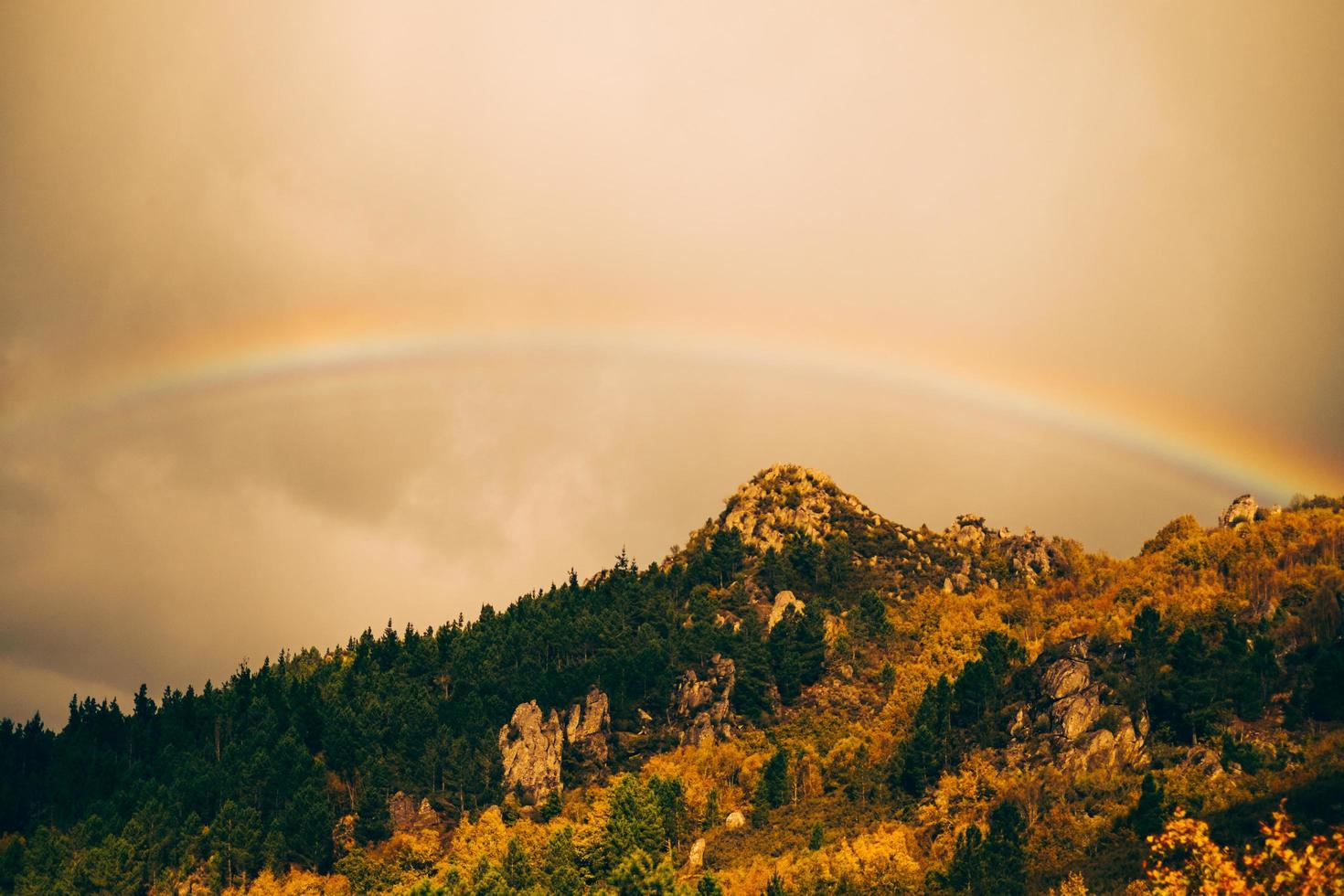 rainbow over mountain photo