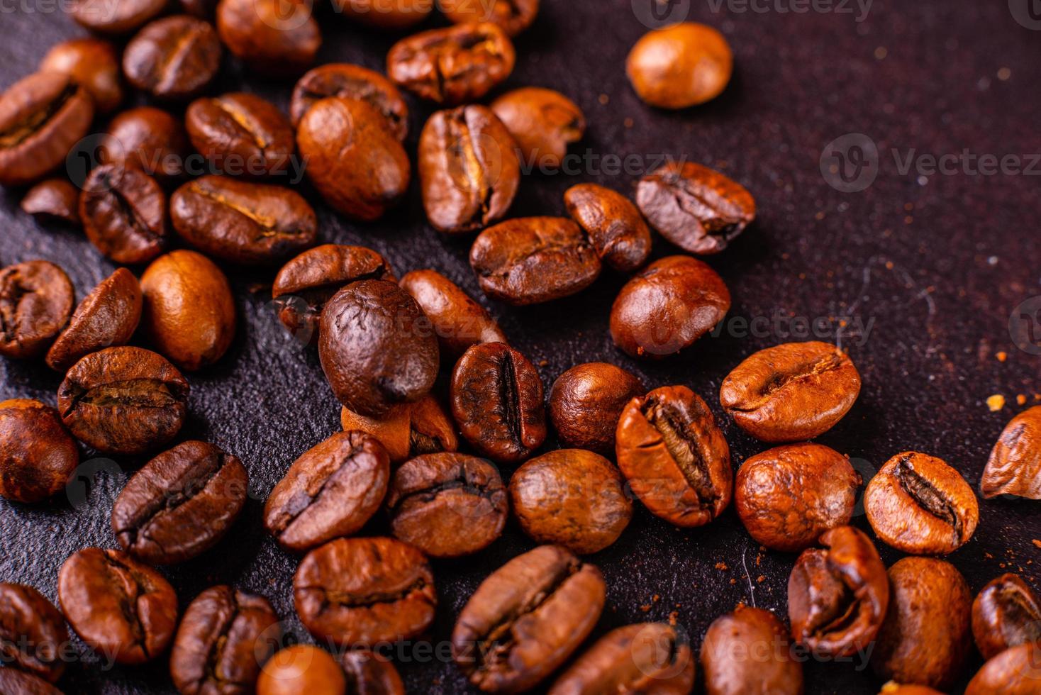 Seeds of fragrant coffee on a dark concrete background photo