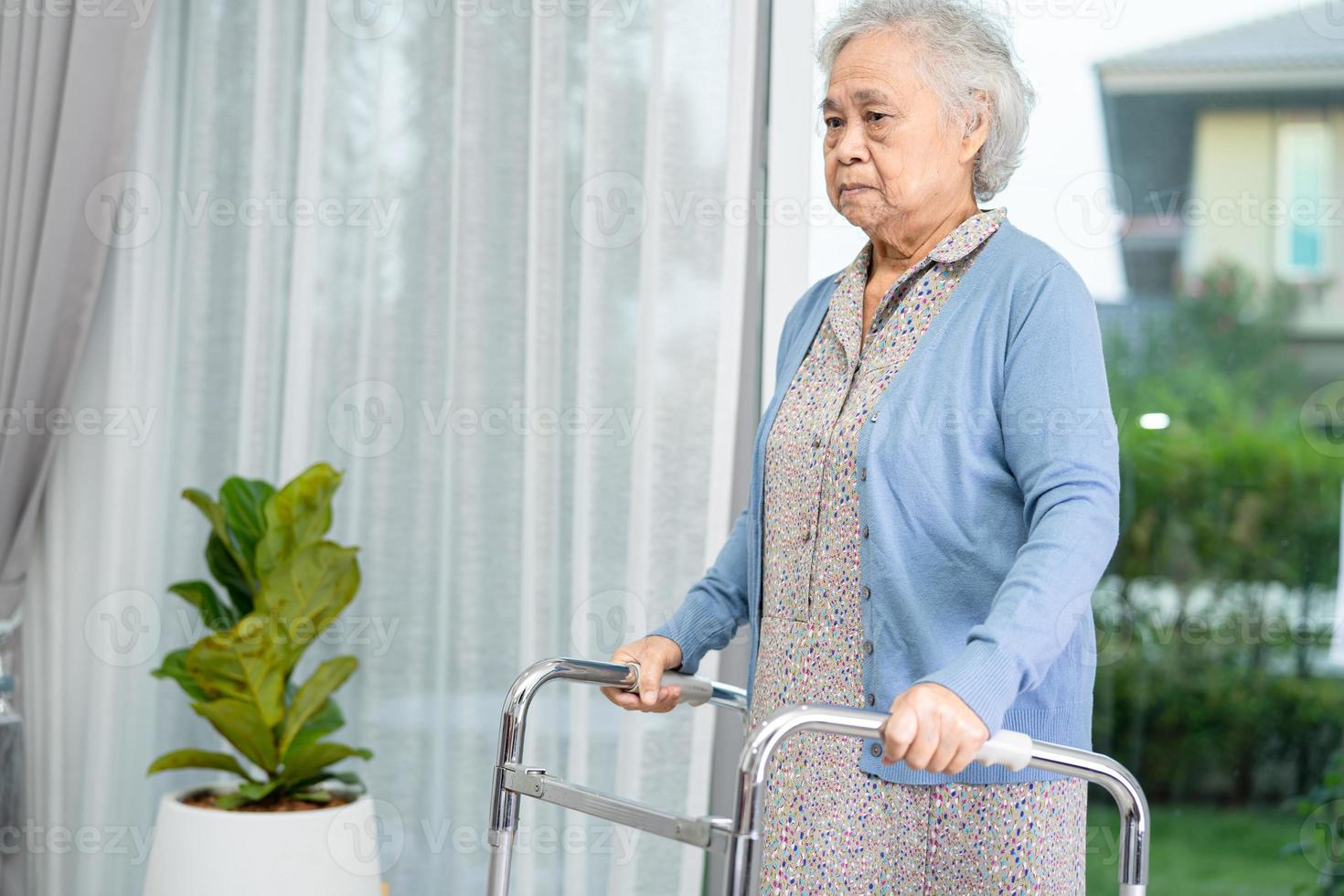Asian senior or elderly old lady woman patient walk with walker at nursing hospital ward, healthy strong medical concept photo