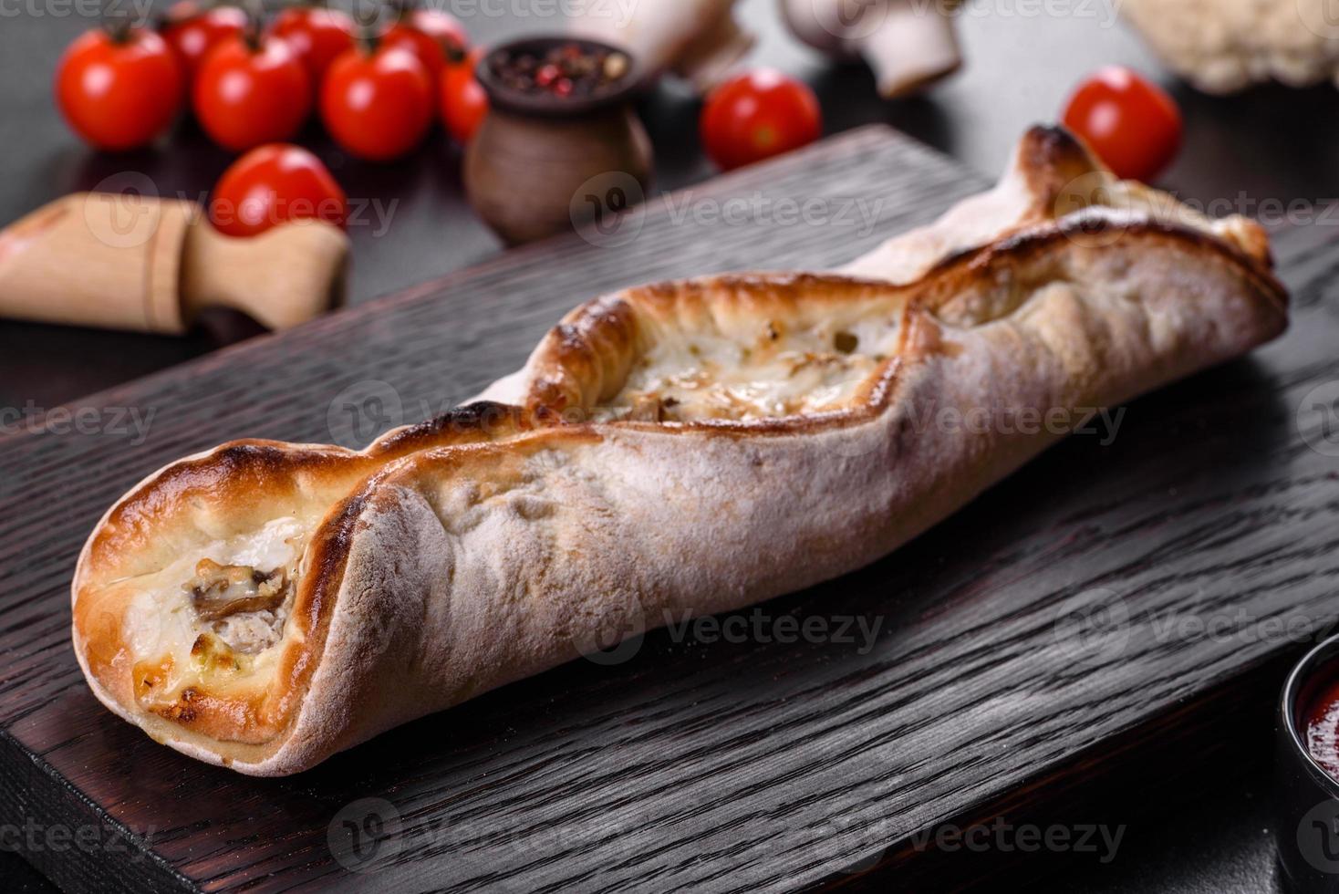 Delicious fresh street pizza with chicken, mushrooms and cheese photo