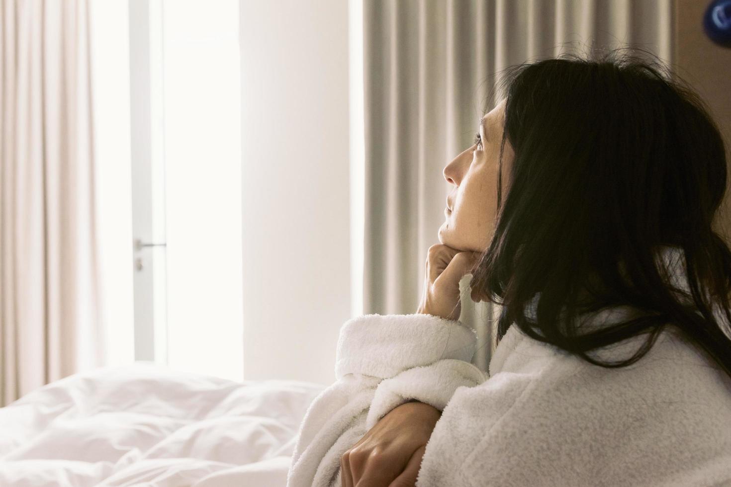 Thoughtful woman in bed photo