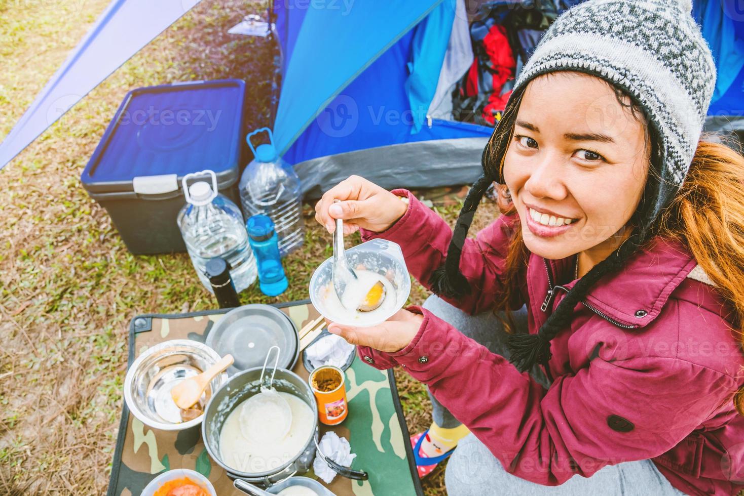 Asian women travel relax in the holiday. camping on the Mountain. sit eat breakfast. Thailand photo