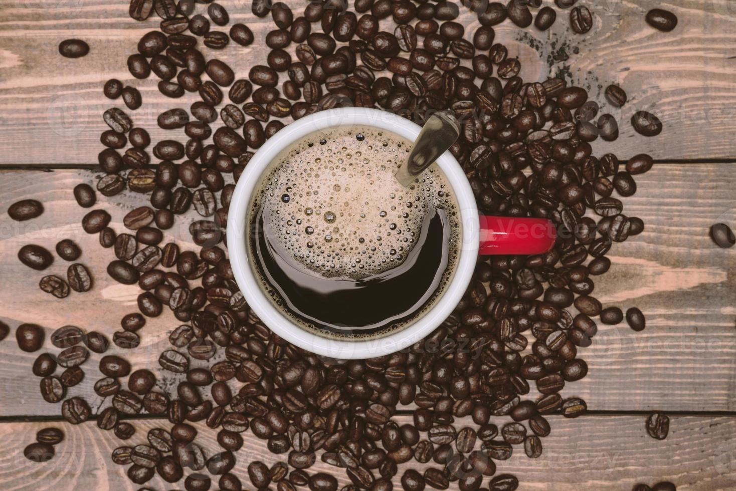 Coffee cup and coffee beans on wooden table. Top view with copyspace for your text photo