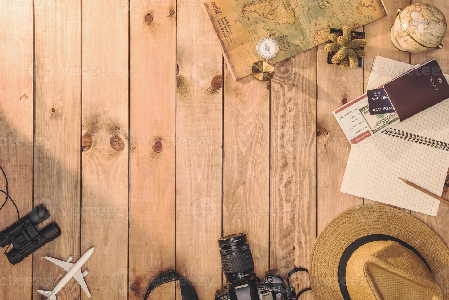 Overhead view of Traveler's accessories Essential vacation items, and Different objects on wooden background. Travel concept background photo