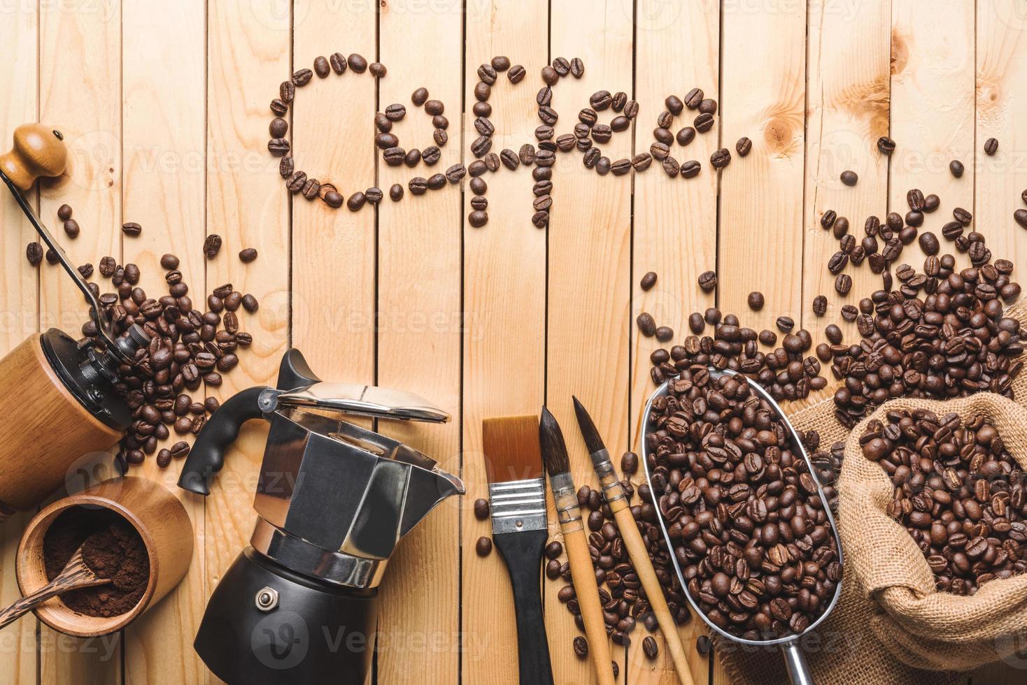 Letter the word coffee made of coffee beans With equipment For drinking coffee photo