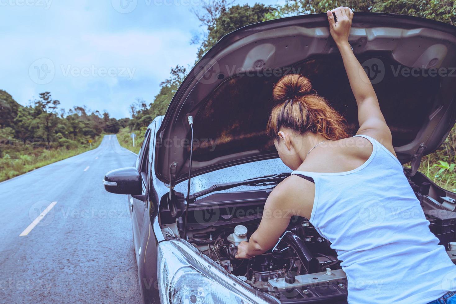 Asian women travel relax in the holiday. Broken car on the street. Thailand photo