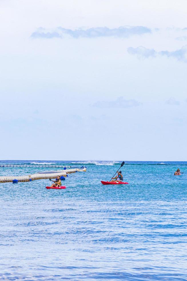 Red canoes on the sea panorama Playa del Carmen Mexico. photo