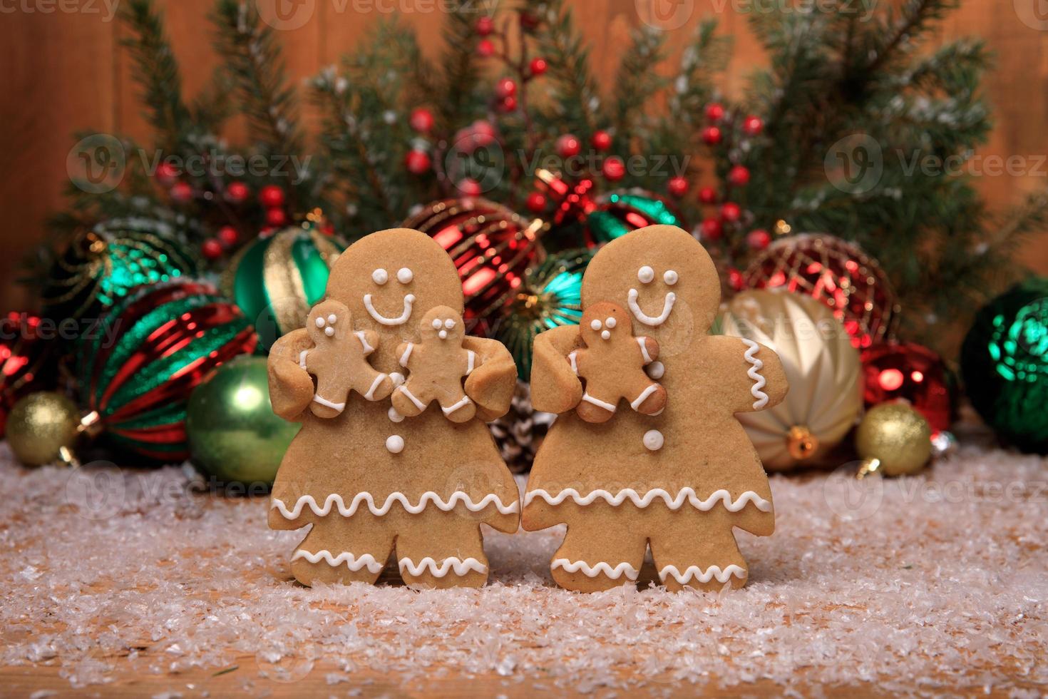 Family of Gingerbreads with 3 kids on Holiday Christmas Background photo