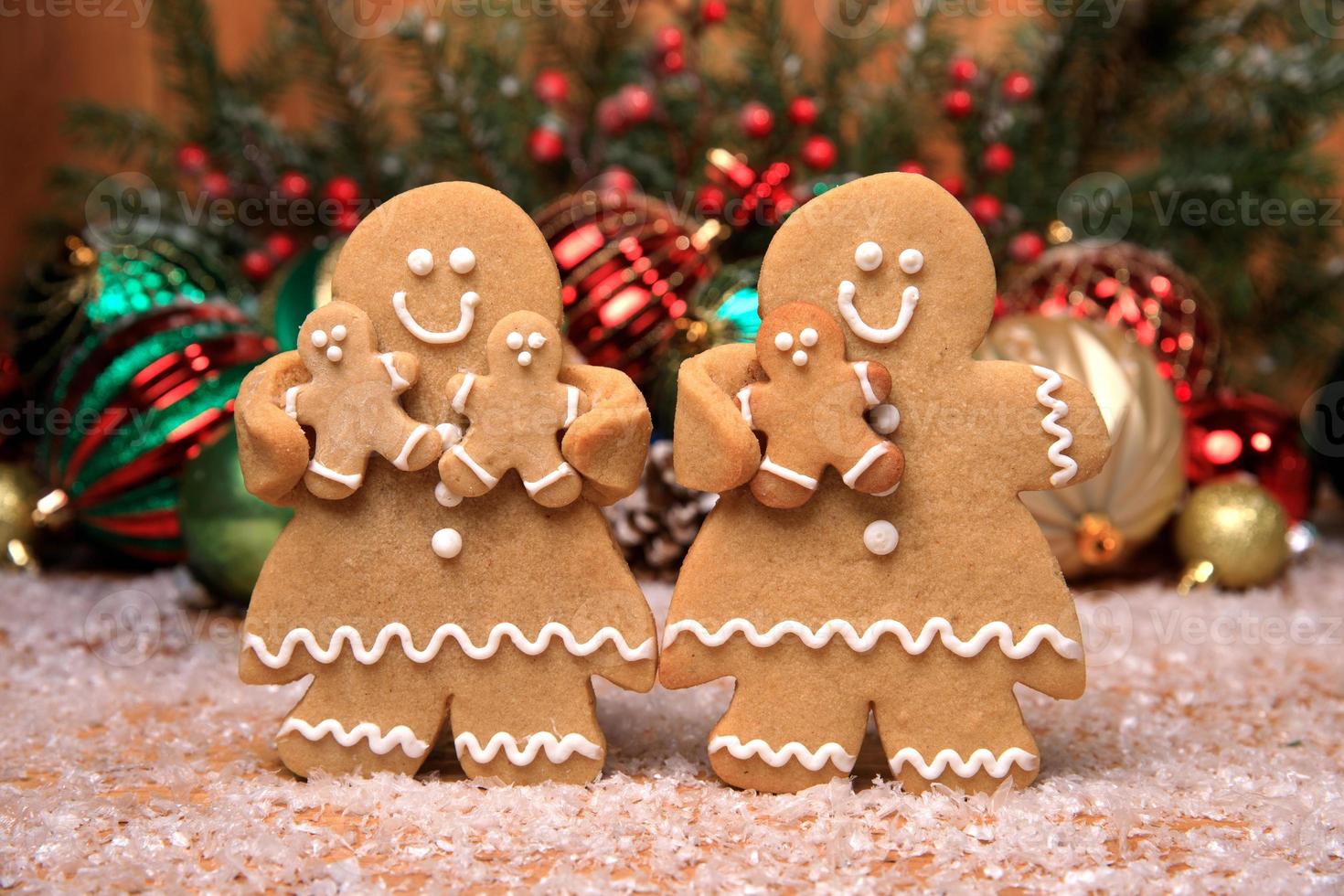 Family of Gingerbreads with 3 kids on Holiday Christmas Background photo