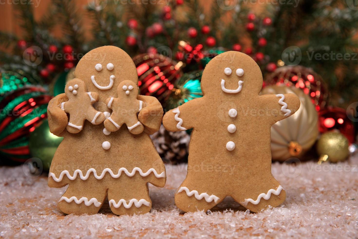 Family of Gingerbreads with 2 kids on Holiday Christmas Background photo