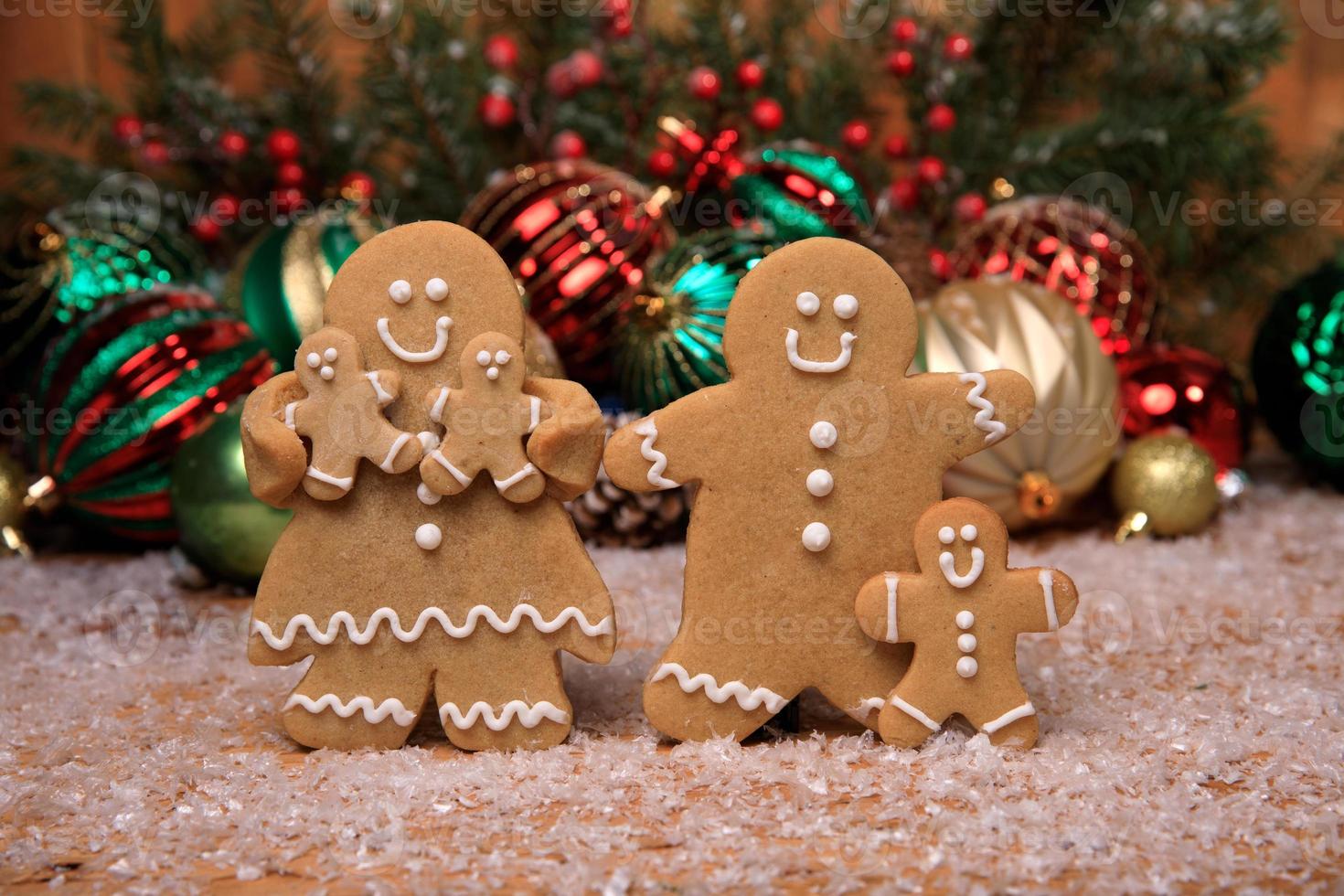 Family of Gingerbreads with 3 kids on Holiday Christmas Background photo