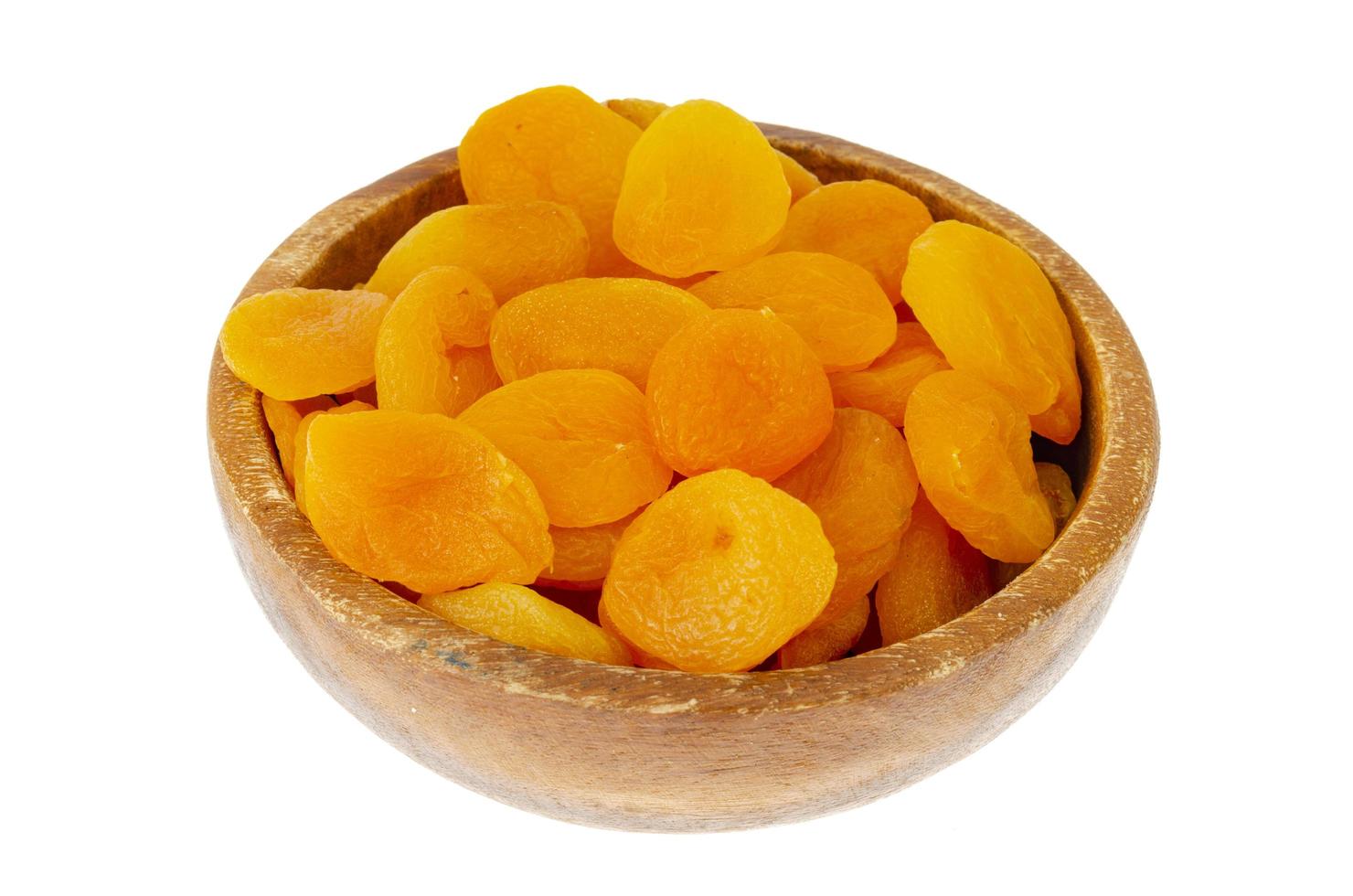 Wooden bowl with dried apricot fruits. Photo