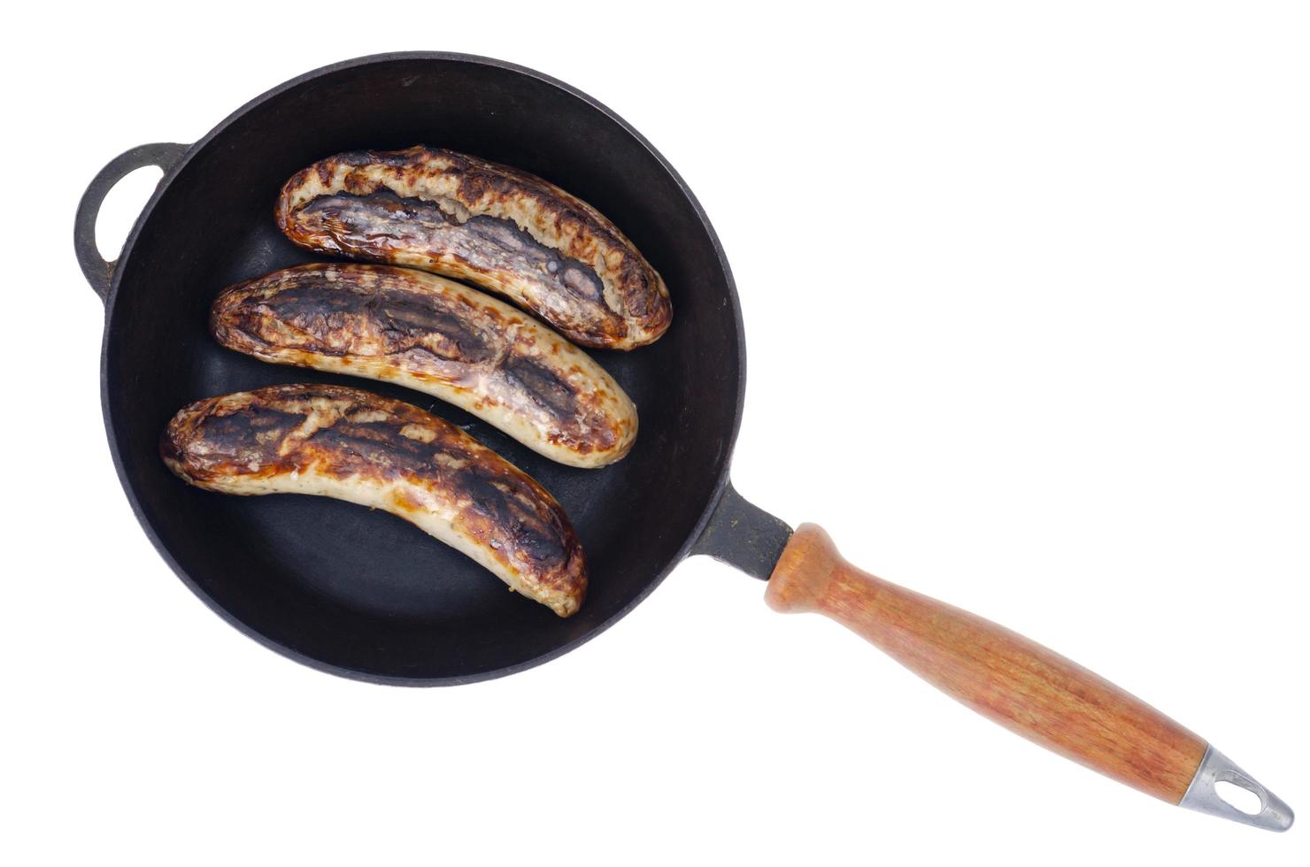 Cast iron pan with grilled sausages on white background photo