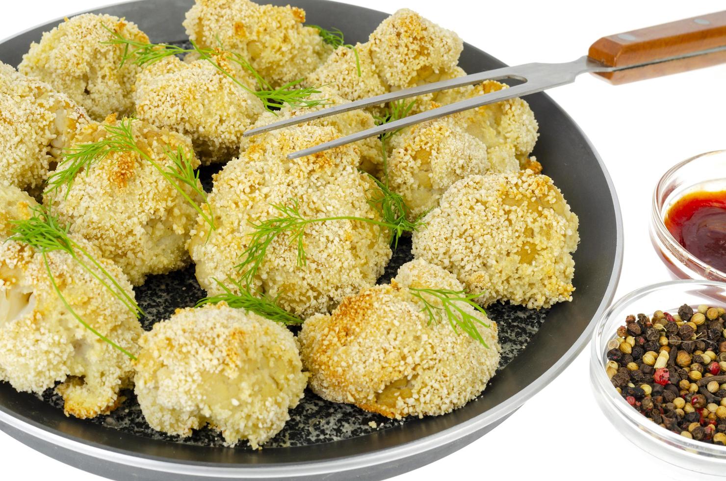 Cauliflower breaded in breadcrumbs in pan. Photo