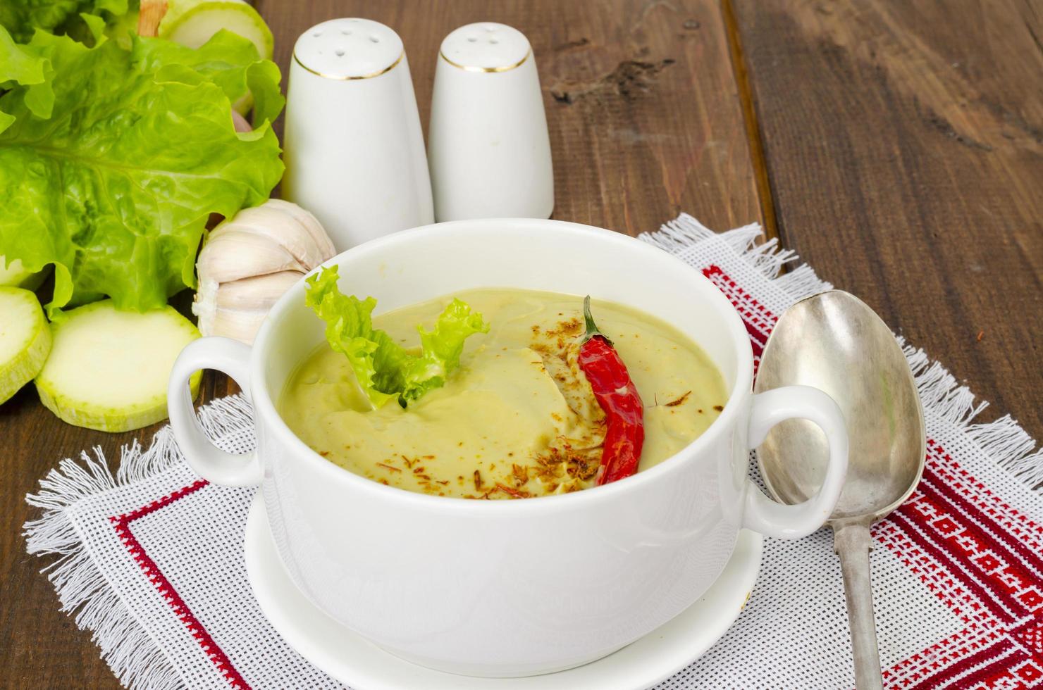 Spicy vegetarian vegetable puree soup green color, healthy eating. photo