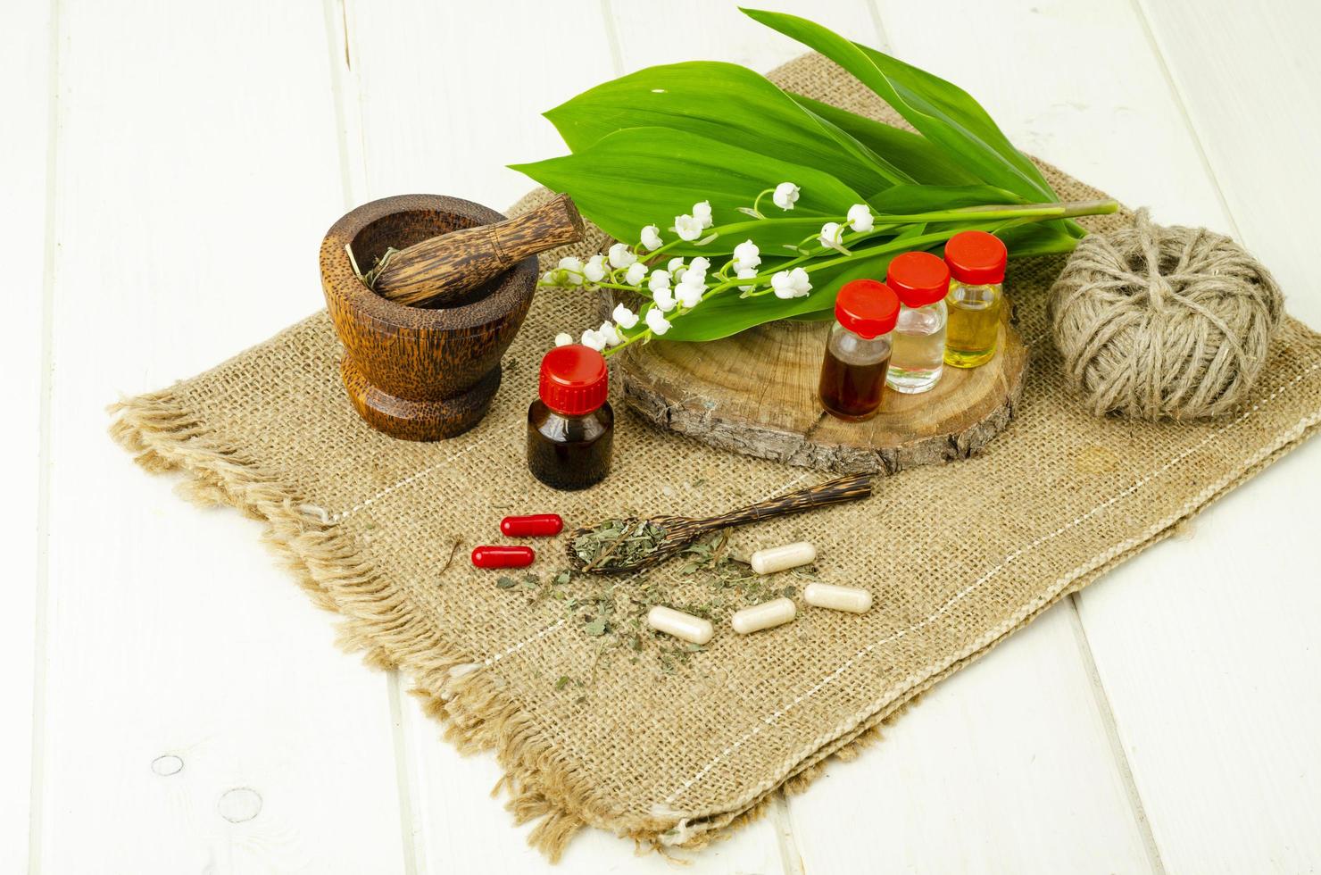 Lily of the valley, essential oil, extract, tincture, infusion, remedy, herbal capsules. Fresh flowers Convallaria majalis photo