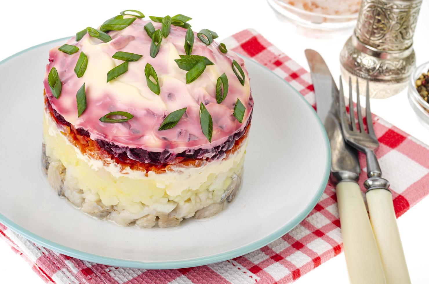 Vegetable salad with potatoes, carrots, deets and herring with mayonnaise photo