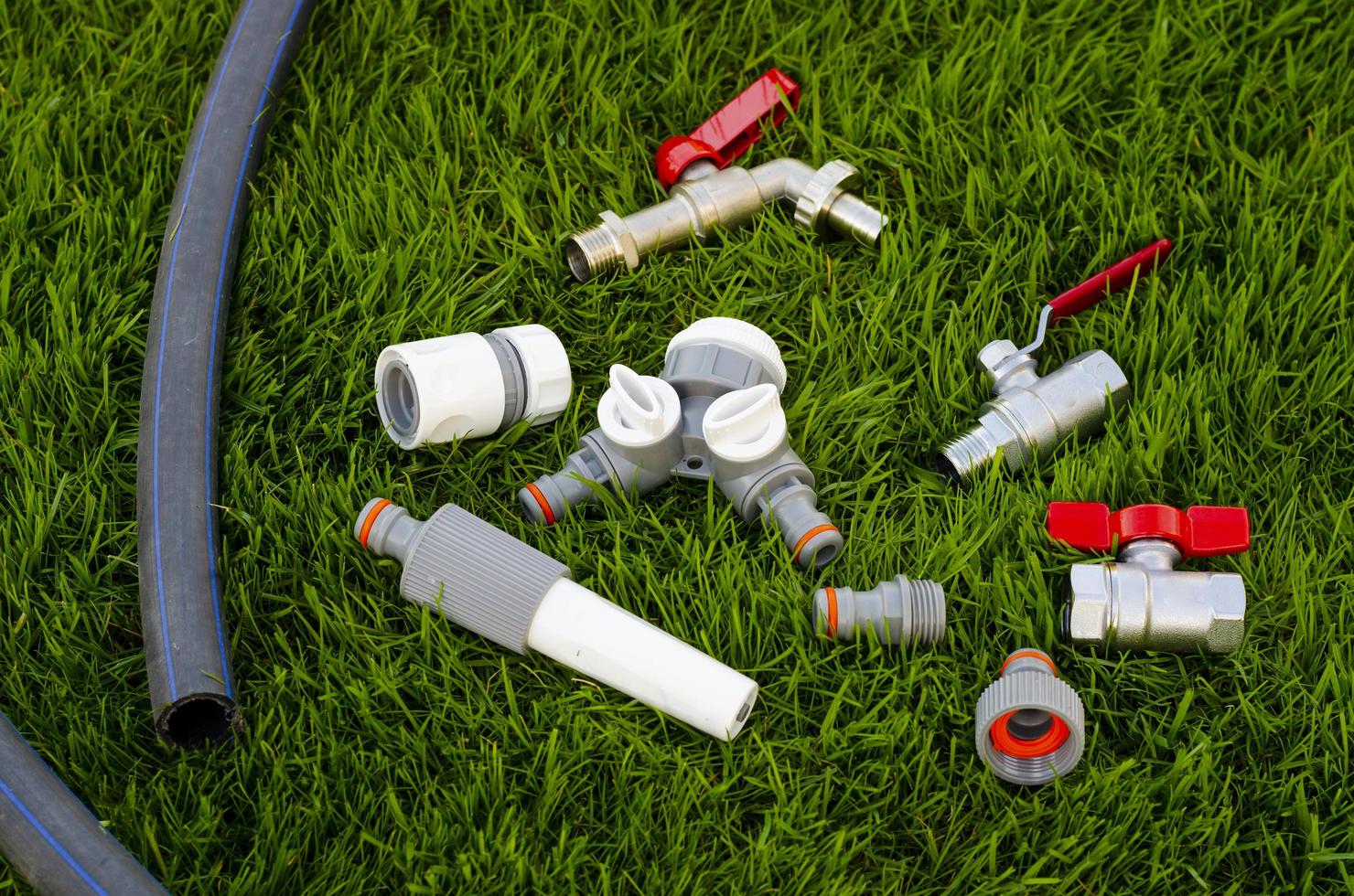 Plastic, watering can, hose for watering the garden, lawn. photo