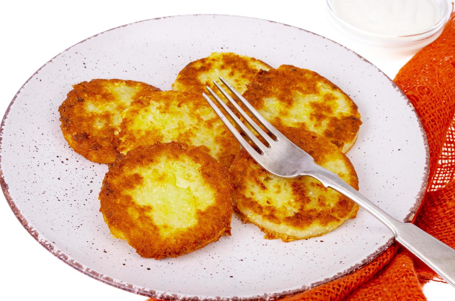 Vegetable marrow pancakes with white sauce. Photo
