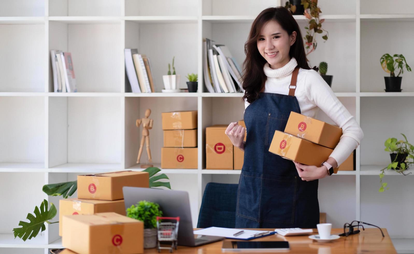 Portrait of Starting small businesses SME owners female entrepreneurs working on receipt box and check online orders to prepare to pack the boxes, sell to customers, sme business ideas online. photo