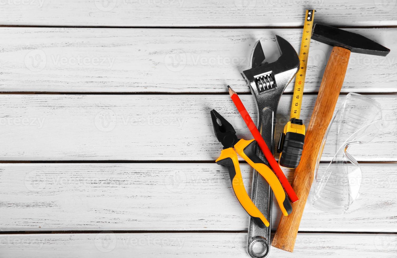 Set of tools on wooden background photo